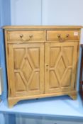 A small pine two drawer and two door side cabinet