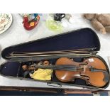 A school violin, two bows and a coffin case