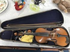 A school violin, two bows and a coffin case