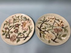 A pair of Austrian wall plaques, decorated with flowers, impressed number 609, 37cm diameter