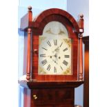 A mahogany long case clock with eight day movement and two subsidiary dials and strike action