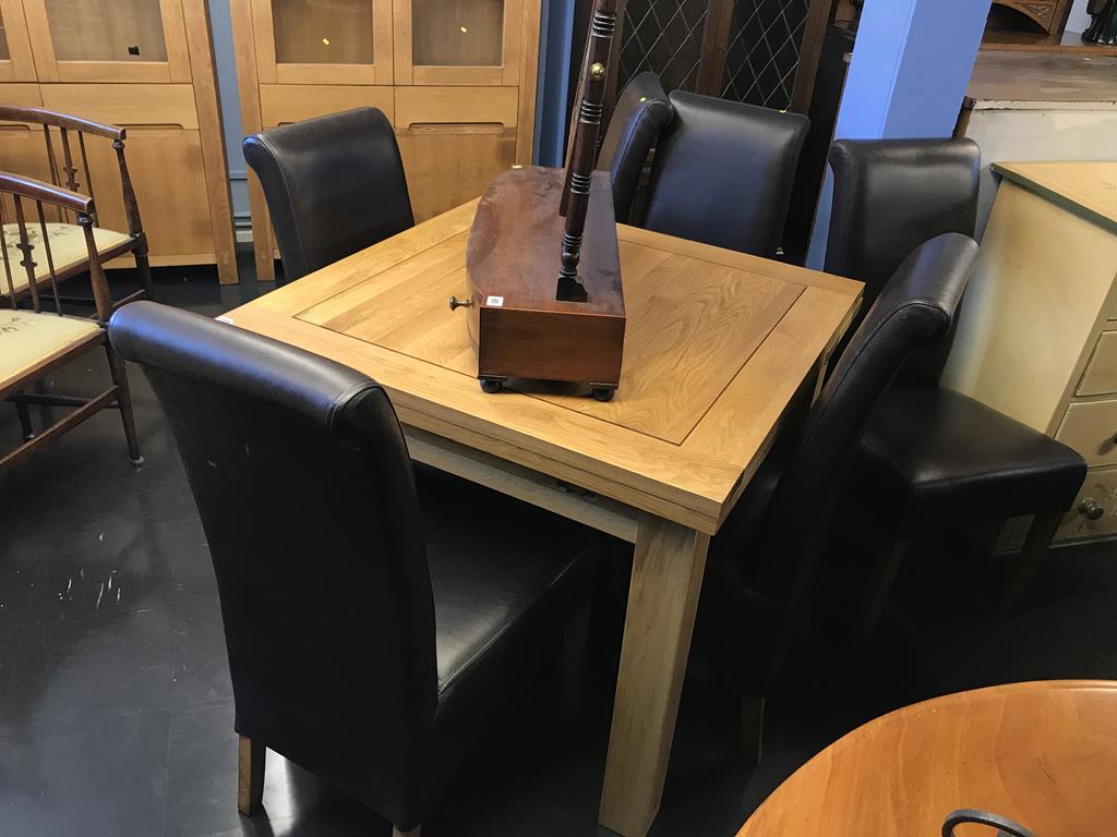 A pale oak drawer leaf table, with six chairs