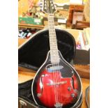 An Antoria electric mandolin, in fitted hard case and a bodhran