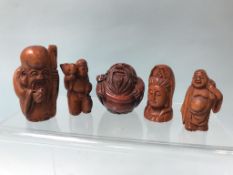 A collection of five carved boxwood netsukes