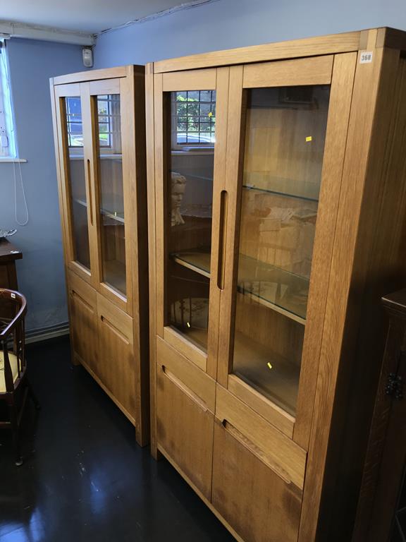 A pair of light oak display cabinets