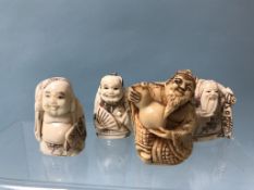 A collection of three bone netsukes and one resin (4)