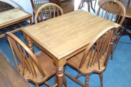 A kitchen table with four Windsor chairs