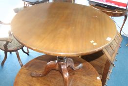 A mahogany tilt top tripod table