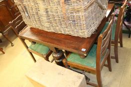 An oak drawer leaf table and four chairs