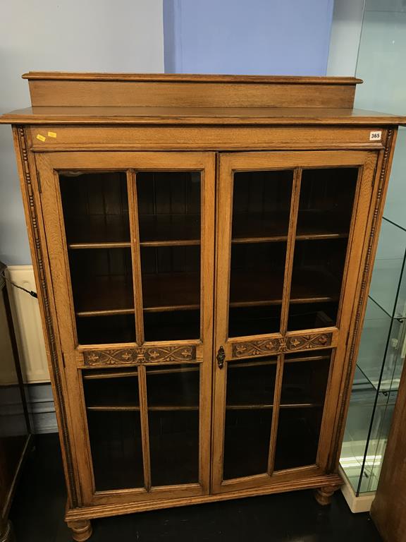 An oak glazed bookcase