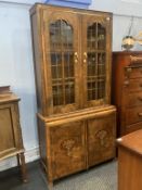 A decorative walnut four door cabinet