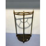 A brass half moon stick stand