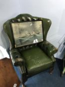 A green leather Chesterfield armchair