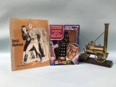 A boxed Dr Who and the Movie Daleks, a model engine and a copy of serial showcases