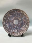 A Crown Ducal Charlotte Rhead tube lined wall plaque, 37cm diameter