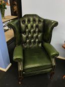 A green leather Chesterfield high back armchair