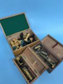 Boxwood chess pieces and two cased field microscopes