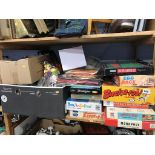 A shelf of assorted vintage board games etc.