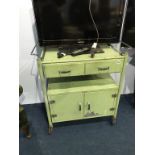 An apple green metal trolley