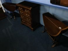 A miniature reproduction mahogany chest of drawers, and two drop leaf tables