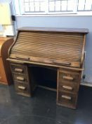 An oak tambour front desk, with six drawers, 121cm wide