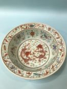 A Chinese circular bowl, decorated with two fighting dragons, 30cm diameter