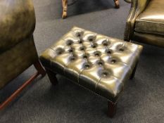 An olive green leather Chesterfield footstool