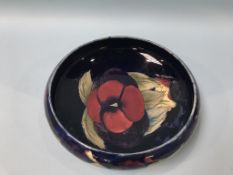 A shallow Moorcroft pottery, 'Poppy' bowl, impressed marks, 27cm diameter