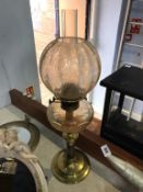An oil lamp, with clear glass reservoir
