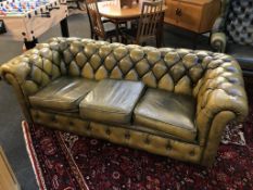 A mustard leather Chesterfield three seater settee (no feet)