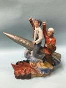 A Chinese Republic group of two workers, mounted on a rocket, 36cm height