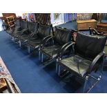 A set of six black leather and chrome armchairs