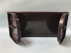 A brown Bakelite book stand