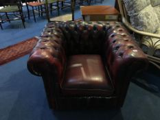 An oxblood Chesterfield club chair