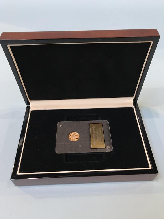 A boxed Queens 65th Coronation quarter sovereign