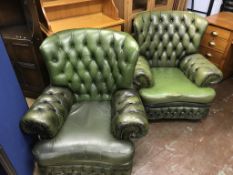 Two green leather Chesterfield armchairs