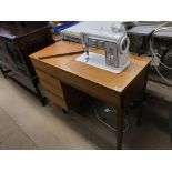 A Singer 708 sewing machine and teak cabinet