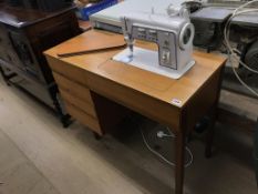 A Singer 708 sewing machine and teak cabinet