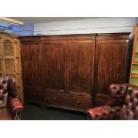 A late 19th century mahogany four door breakfront wardrobe, with dentil cornice, three drawers,