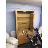 A light oak two door glazed display cabinet