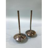 A pair of Taper holders, stamped 'Kabwe silver'