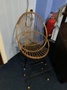 A wirework magazine rack and canework chair