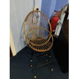 A wirework magazine rack and canework chair