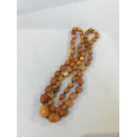 A string of amber coloured beads, 48g approx.
