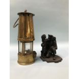 Five various modern miners lamps and four carved coal figures