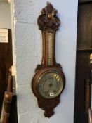 A carved oak banjo barometer