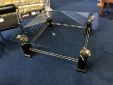 A decorative glass top square coffee table, with four gilt lion supports, gilt stretcher and