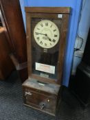 An oak cased time clock