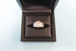 A Berry's 18ct platinum and diamond brilliant cut ring, light yellow diamond centre stone surrounded