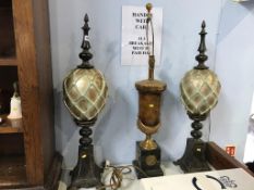 A table lamp and a pair of obelisks